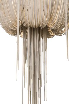 a large chandelier made out of wood sticks and white fabric hanging from the ceiling