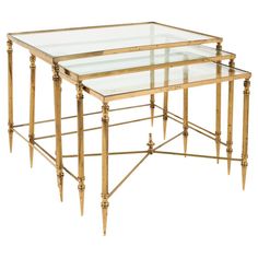 a set of three gold metal and glass nesting tables