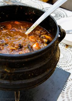 a pot filled with stew sitting on top of a table