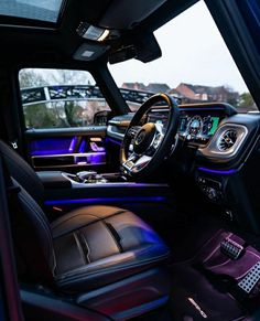 the interior of a vehicle with purple lighting