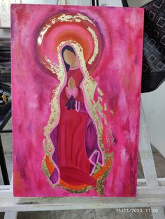 a painting of a virgin mary in pink and gold