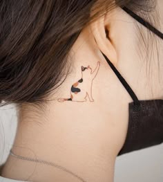 a woman with a cat tattoo on her neck