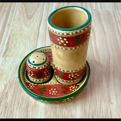 a cup and saucer sitting on top of a wooden table next to each other