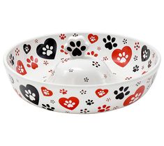 a white bowl with red and black hearts and paw prints on the bottom, sitting in front of a white background