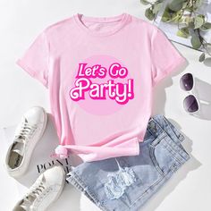 a pink shirt that says let's go party next to denim shorts and sneakers