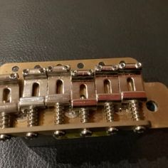 a close up of a guitar bridge on a table