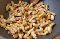 some food is cooking in a wok on the stove and ready to be cooked