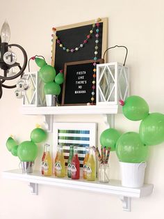 some balloons are hanging on the wall above a shelf