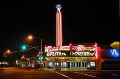 an old movie theater lit up at night