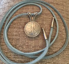 Style as a Western Lariat Necklace or Boot Bolo! Lady Liberty Concho (1.25 inches wide) on Sky Blue Leather Lariat (45 inches long) with bolo tips (1.25 inches long). Blue Lariat Bolo Tie For Gift, Blue Western Style Concho Necklace, Blue Western Lariat Jewelry, Brown Concho Bolo Tie Lariat, Bohemian Turquoise Lariat Bolo Tie, Adjustable Brown Lariat Bolo Tie, Lariat Necklace Silver, Pearl Lariat Necklace, Tandy Leather