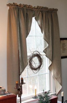 a window with a wreath hanging on it's side