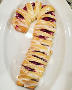 a white plate topped with pastry covered in icing