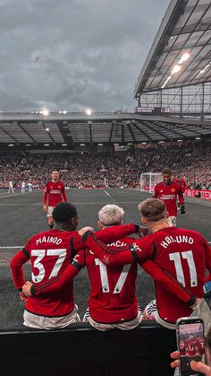 a group of men standing on top of a soccer field