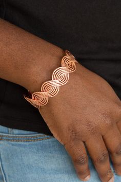 Delicately hammered in shimmery detail, shiny copper wires braid into a brilliant cuff around the wrist for a casual look.