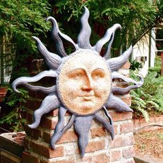 a sun face on top of a brick wall