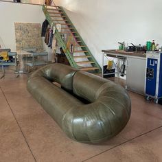 a living room filled with furniture next to a stair case