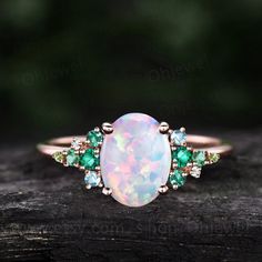 "This is a lab opal engagement ring in solid gold,about 7x9mm oval cut.  The side stones are round Lab emeralds,topaz,peridot and moissanites. The band width is about 1.4mm. It can be made in any ring size. However please contact me to custom make it to a special big or small size. It can be made in white gold,rose gold or yellow gold with 14k or 18k. However for some people who are nickel allergic,I can also make it to 925 sterling silver to make you can wear it. The ring is handmade,very high quality! 30 days money back guarantee. Returns & Warranty 30-Day money back guarantee (starting from the day of delivery). \"Made to Order\" purchases qualify for our 30-day money back guarantee. The 30-day money back guarantee gives you time to make sure your purchase is perfect. If you need to  re Luxury Green Opal Ring, Green Opal Engagement Ring, Green Opal Ring, Emerald Opal Ring, Opal Emerald Ring, Opal And Emerald Engagement Ring, Peridot And Opal Ring, Emerald Opal Engagement Ring, Emerald And Opal Ring