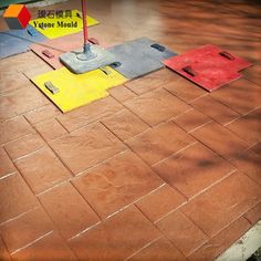 an upside down umbrella sitting on top of a tiled floor next to a street sign