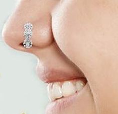 a woman's nose with an earring on top of her nose and the bottom part of her mouth