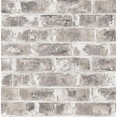 an old brick wallpaper with white and gray paint on the bricks, as well as grey