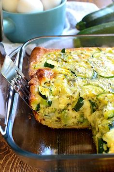 a close up of a casserole in a pan on a table with eggs