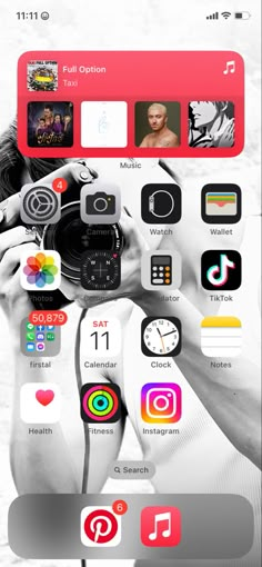 an iphone screen with various icons on it and a person holding a camera in front of them