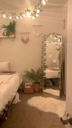 a bedroom with a bed, mirror and plants on the wall next to each other