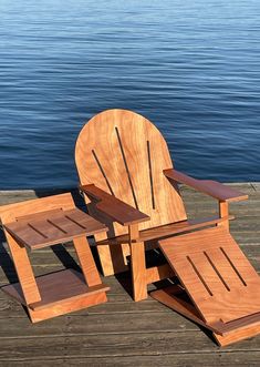 a wooden chair sitting on top of a wooden dock