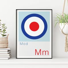 an art print with the word mod in red, white and blue on it next to some books