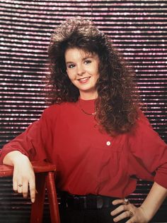 a woman in a red shirt posing for a photo