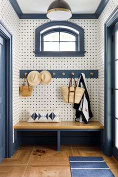 the entryway is decorated with blue and white wallpaper