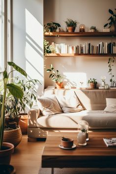 a living room filled with lots of plants next to a wall mounted bookshelf