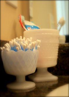 three toothbrush holders sitting on top of a counter