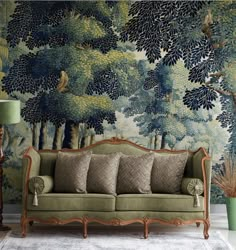 a green couch sitting in front of a forest wallpaper