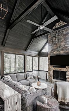 a living room filled with lots of furniture and a flat screen tv mounted to the wall