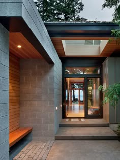 an entry way to a modern home with concrete and wood