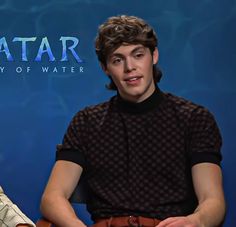 two young men sitting next to each other in front of a blue background with the words avatar on it