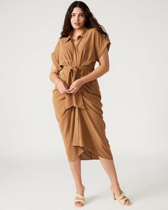 The TORI dress has a rolled collar and cuffed short sleeves, with an adjustable gathered tie-front waist and a high-low hem. The dress is finished with a lightweight woven crepe fabric, giving it a polished look. Tie-front midi shirt dress Button-up closure Elastic in back Length: 48" 100% polyester Hand wash Stephanie is 5ft 10in and is wearing a size 12 Maelyn is 5ft 11.5in and is wearing a size 4 Imported Cassie Style, Beige Knit Dress, Brown Knit Dress, Rolled Collar, Gathered Dress, Dress Beige, Ribbed Knit Dress, Midi Shirt Dress, Button Dress