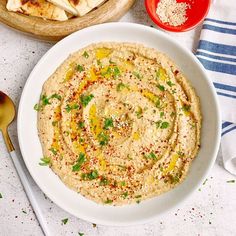 hummus and pita bread on a white plate