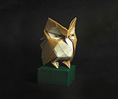 an origami owl head on top of a green block