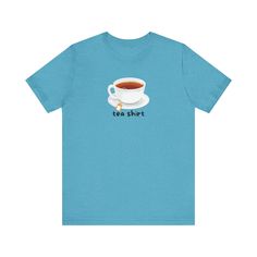 A fun and quirky T-Shirt that says "Tea Shirt" with a picture of a cup of tea, perfect for tea lovers and those who enjoy a touch of humor in their wardrobe. This T-Shirt exudes a laid-back vibe and can be worn casually or as a statement piece. Ideal for tea enthusiasts and those who appreciate whimsical designs. Relevant for tea parties, casual outings, and everyday wear. Key Features: Material: 100% Airlume combed and ring-spun cotton (Ash & Heather colors: cotton-poly blends) Fit: Retail fit Quirky T Shirts, Tea Shirt, A Cup Of Tea, Tea Lovers, Tea Parties, Cup Of Tea, Jersey Tee, Tea Lover, Shirt Price