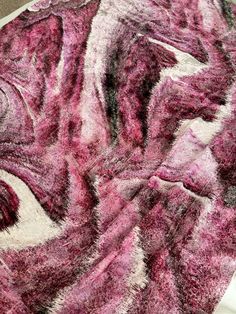 a pink and white area rug on top of a table