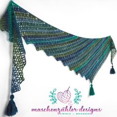 a green and blue shawl with tassels hanging from it