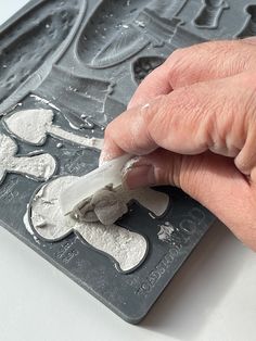 a person is peeling something off of a cookie sheet