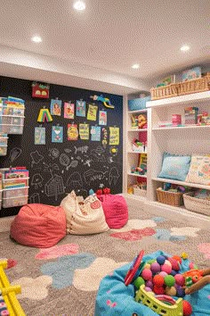 a child's playroom with chalkboard walls and toys on the floor in front of it