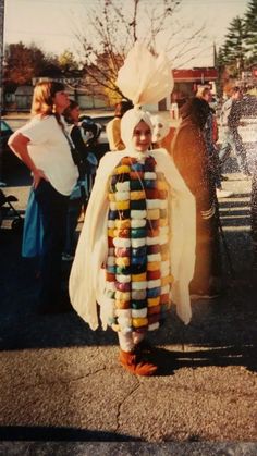 a young boy dressed up as a candy corn cosplay for the costume contest