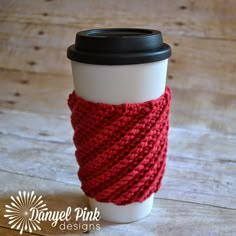 a coffee cup with a knitted wrap around the sleeve on it and text reading crocheted coffee cozy