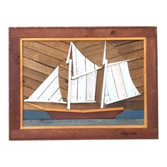 a painting of a sailboat is hanging on a wooden paneled wall with planks