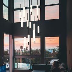 a living room filled with furniture and large windows