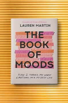 the book of moods by lauren martin on a yellow background with orange and pink stripes